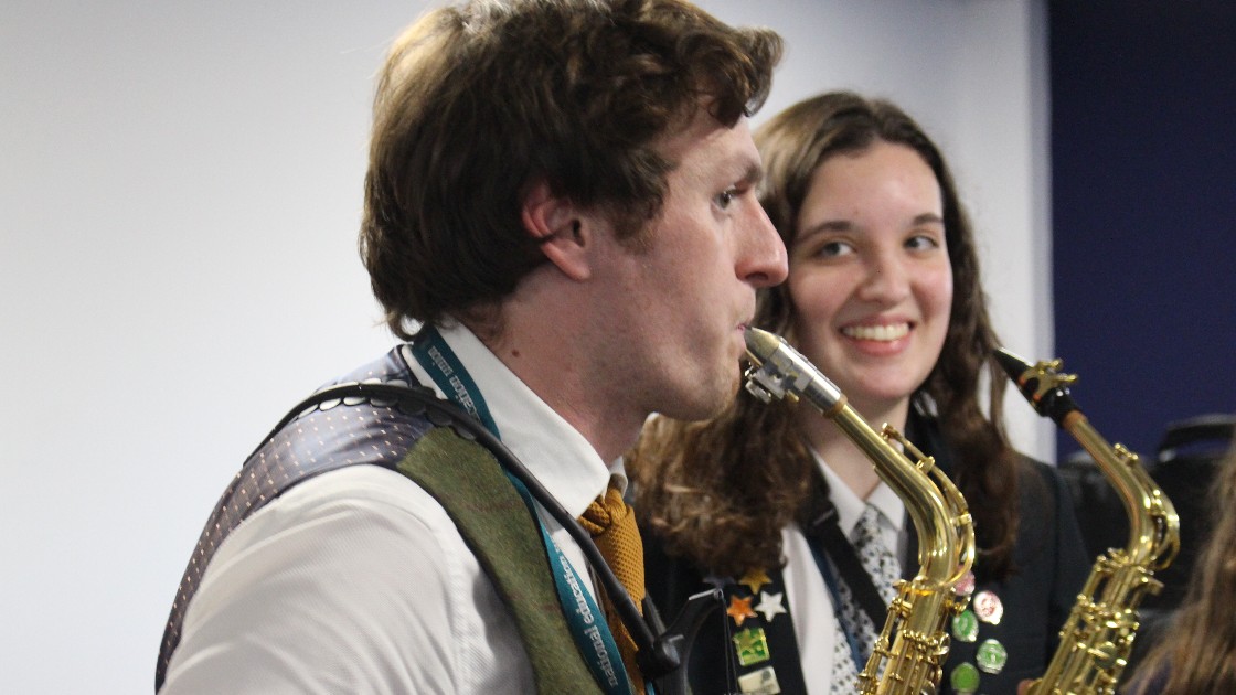 Teacher and student playing saxophones