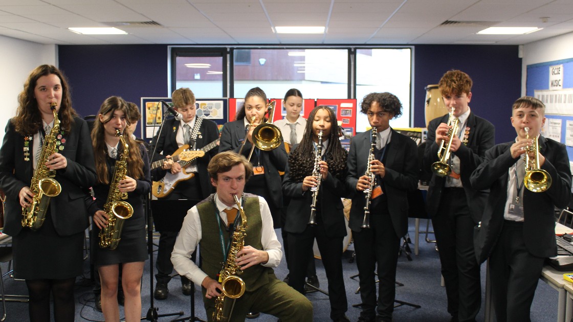 Students playing musical instruments in a rehearsal