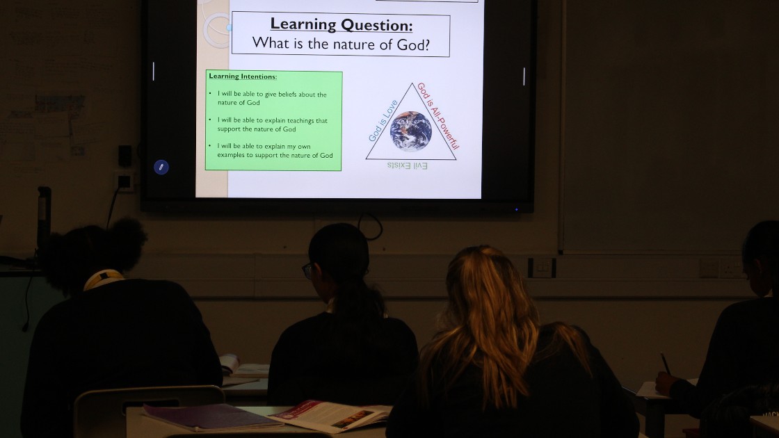 Students in an RS lesson viewing a slide on the nature of God