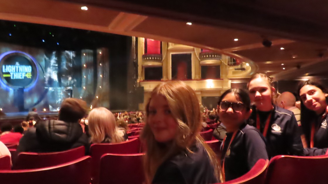 Year 9 students seated in a theatre auditorium, facing the stage for The Lightning Thief
